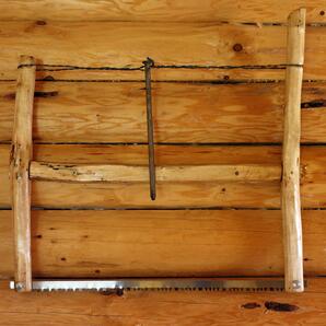 Wood Saw Mounted on Log Wall
