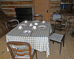 Interior of Log Cabin with Full Table Setting for Four