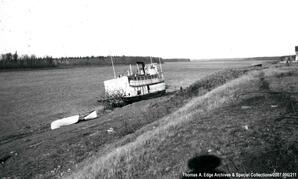 One boat on a shoreline, [Alberta].