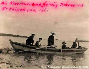 Four people in a boat, Fort Chippewyan. A note on the front reads: ""His Reverend and family marooned; Ft. Chippewyan, 1910"". A note on the back reads: ""Edith and Alex leaving to catch [Calana] [Frazans] boat on their way out to Edmonton, 1910"".