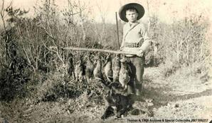 One boy with dead game birds.