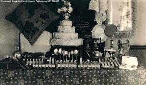 Decorated wedding cake with ornate cutlery and other utensils