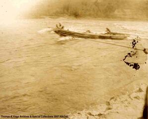 One boat in a small rapids with two men onboard, [Alberta].