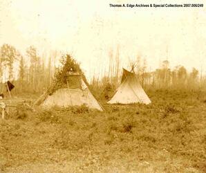 Two teepees in a field, [Alberta].