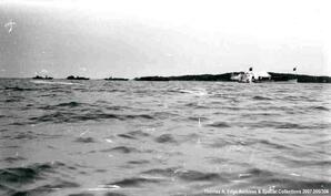 Five boats traveling down a body of water, [Alberta].