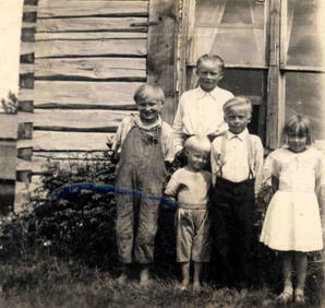 The Karvonen children outside their home in Hollow Lake, Alberta