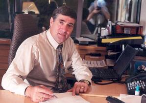 Dominque Abrioux seated at his desk in President's office, Athabasca, Alberta