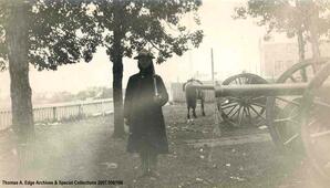 Officer with gun beside cannons, [Alberta].