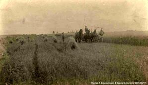 One man driving four horses attached to plow, while one man walks beside, [Alberta].
