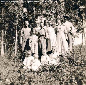 Portrait of a family, background of bushes and trees, [Alberta]. Note on back reads" ""Part of the [Florence?] Family."
