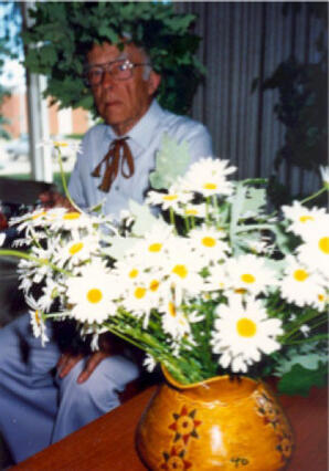 Latvian man with Ivy Head Wreath, Daisies and Traditional Vase