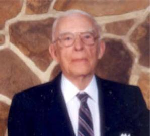 Man with Glasses in Front of Stone Wall