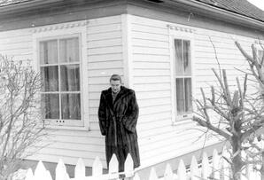 Emma in front of first home