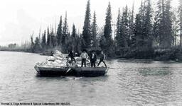 Two or more scows with men and supplies onboard. The scows are attached to a vessel ahead of them and appear to be being towed, [Alberta].