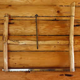 Wood Saw Mounted on Log Wall